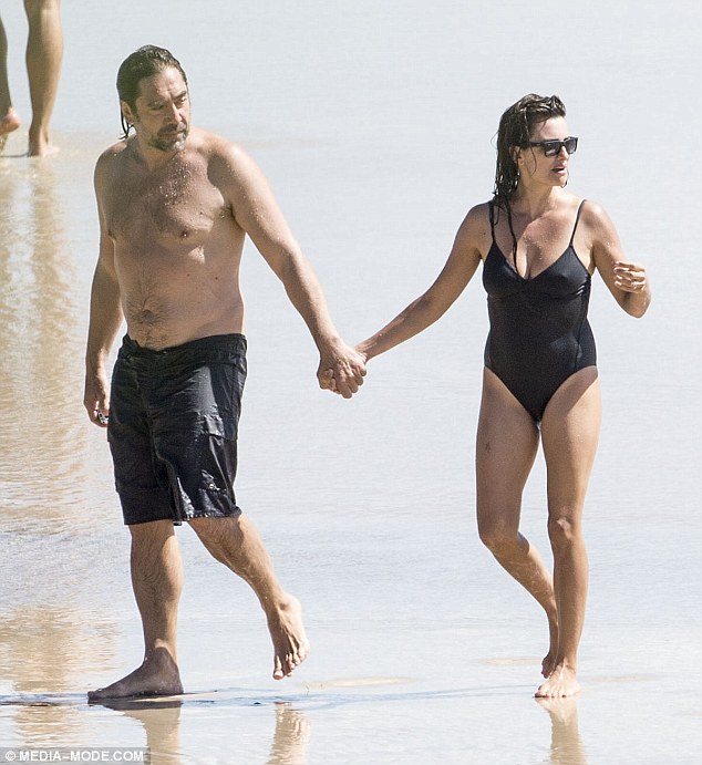 Perfect couple: The smitten pair held hands as they emerged from the water together