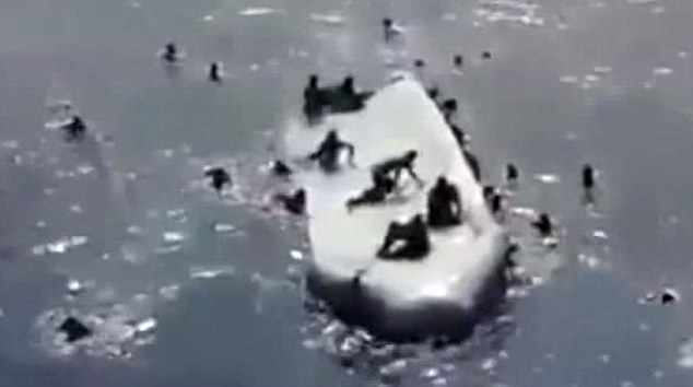 People are spotted clinging to the top of the capsized boat, while others are struggling in the water. It is feared hundreds of migrants have drowned after the vessel toppled, and a huge rescue operation is still taking place