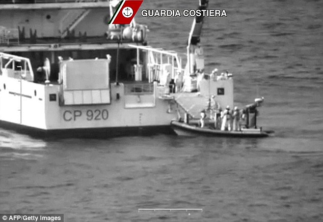 Saviors: This image released by the Italian Coast Guards today shows rescuers take part in the operation off the coast of Sicily to look for survivors in the wake of the shipwreck