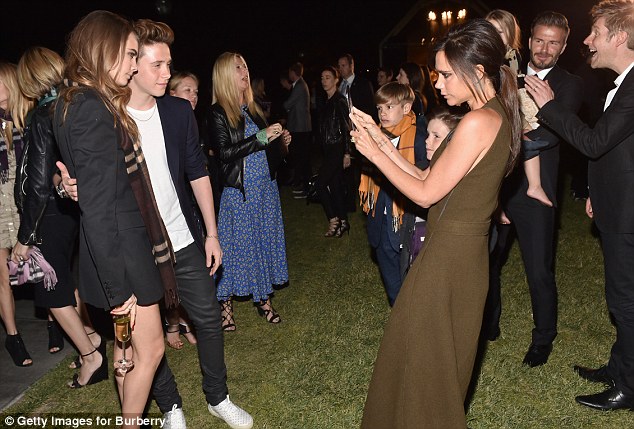 On the other side of the camera: Brooklyn asked his mother to take a selfie of him with supermodel Cara Delevingne at the party 