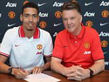 MANCHESTER, ENGLAND - APRIL 21:  (EXCLUSIVE COVERAGE) Chris Smalling of Manchester United (L) poses with manager Louis van Gaal after signing a contract extension at Aon Training Complex on April 21, 2015 in Manchester, England.  (Photo by John Peters/Man Utd via Getty Images)