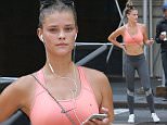 Victoria's Secret swimsuit cover model Nina Agdal has a sweaty jogging workout in the busy streets of New York City in the hot summer. The model was spotted looking at her iphone during a break as she looked into the camera as a man behind her checked out her backside. \n\nPictured: Nina Agdal\nRef: SPL1048764  110615  \nPicture by: Turgeon/Prahl Splash News\n\nSplash News and Pictures\nLos Angeles: 310-821-2666\nNew York: 212-619-2666\nLondon: 870-934-2666\nphotodesk@splashnews.com\n