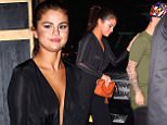 New York, NY - Singer, Selena Gomez, wowed as she was seen leaving  a dinner with friends at Hotel Chantelle.  She was seen in a sheer low-cut shirt, high-waist trousers, and an orange Gucci handbag.\nAKM-GSI          June 22, 2015\nTo License These Photos, Please Contact :\nSteve Ginsburg\n(310) 505-8447\n(323) 423-9397\nsteve@akmgsi.com\nsales@akmgsi.com\nor\nMaria Buda\n(917) 242-1505\nmbuda@akmgsi.com\nginsburgspalyinc@gmail.com