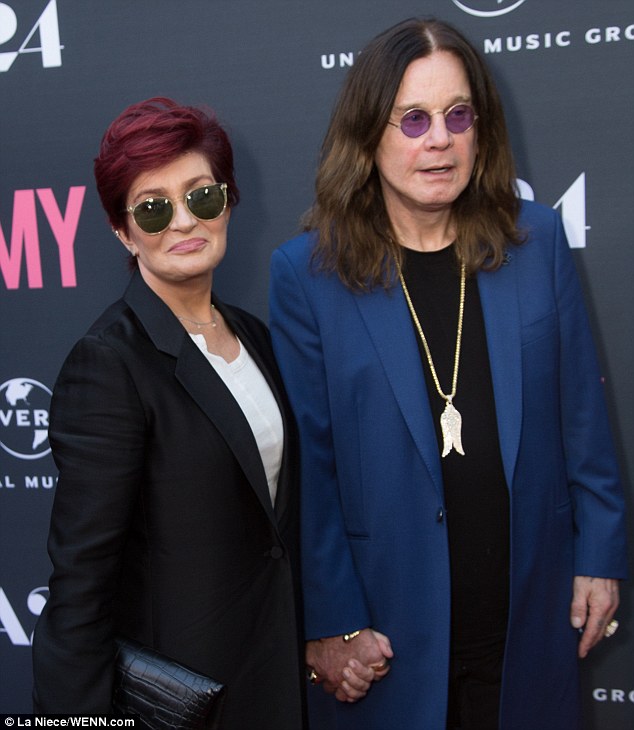 Similar styles: While Sharon wore a black pantsuit and white blouse, Ozzy sported a black top and trousers with a blue coat