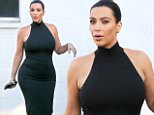 Kim Kardashian trying to hide her baby bump and went a bit too heavy on the bronzer leaving the studio July 7, 2015 X17online.com