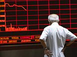 An investor watches an electronic board showing stock information at a brokerage office in Beijing, China, July 7, 2015. Chinese stocks fell on Tuesday, taking little comfort from a slew of support measures unleashed by Beijing in recent days, and unnerved by Chinese Premier Li Keqiang's failure to mention the market chaos in a statement on the economy. REUTERS/Kim Kyung-Hoon       TPX IMAGES OF THE DAY