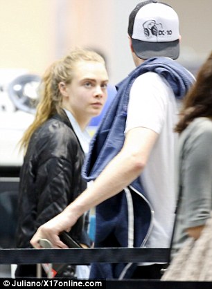 Fancy seeing here! Cara hugged a mystery man as she made her way through to security checks