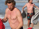 Simon Baker displays a large stomach scar as he goes shirtless at Bondi Beach after a cold swim while his wife watches from the shore all rugged up. Photos taken in Sydney on Thursday 9th July 2015.\\nCarlos Costas.