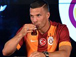Galatasaray's new German forward Lukas Podolski (R) drinks Turkish tea next to Galatasaray's president Dursun Ozbek (L) during a signing cerenomy on July 4, 2015 at the TT Arena stadium in Istanbul. Lukas Podolski  signed a three year contract with Galatasary. AFP PHTO/ OZAN KOSEOZAN KOSE/AFP/Getty Images