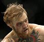 Conor McGregor, left, punches Chad Mendes during their interim featherweight title mixed martial arts bout at UFC 189 Saturday, July 11, 2015, in Las Vegas. (AP Photo/John Locher)