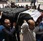 Mourners carry the coffin of Egyptian actor Omar Sharif for a funeral procession at the Hussein Tantawi Mosque in Cairo, Egypt, Sunday, July 12, 2015. Sharif, the Egyptian-born actor with the dark, soulful eyes who soared to international stardom in movie epics, "Lawrence of Arabia" and "Doctor Zhivago," died in a Cairo hospital of a heart attack, on Friday, July 10. He was 83. (AP Photo/Hassan Ammar)