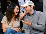 LOS ANGELES, CA - DECEMBER 19:  Mila Kunis (L) and Ashton Kutcher attend a basketball game between the Oklahoma City Thunder and the Los Angeles Lakers at Staples Center on December 19, 2014 in Los Angeles, California.  (Photo by Noel Vasquez/GC Images)