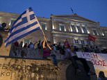 A woman waves a Greek flag during an anti-austerity pro-government rally in front of the parliament building in Athens, Greece, June 21, 2015. Greece's leftwing government believes it can reach a deal with its creditors, Finance Minister Yanis Varoufakis said on Sunday after almost eight hours of meetings to thrash out proposals ahead of a last-ditch summit with European leaders on Monday. REUTERS/Marko Djurica