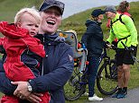 ABERFELDY, SCOTLAND - JULY 11:  Zara Phillips and daughter Mia Tindall (L) support husband Ex England rugby star Mike Tindall (2ndR) and Scottish player Rory Lawson (R), grandson of legendary rugby commentator Bill McLaren, compete in the grueling Artemis Great Kindrochit Quadrathlon in Loch Tay Scotland on July 11, 2015 in Aberfeldy, Scotland.  (Photo by Nigel Roddis/Getty Images for Artemis Quadrathlon)