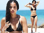 140014, EXCLUSIVE: Zoe Kravitz rocks a black bikini and elaborate silver body jewelry as she hits the beach in Miami. The singer and actress showed off her incredible figure in a black bikini and silver body chains across her chest and legs as she cooled off in the ocean after relaxing on a sun lounger. The beauty then rehydrated with a fresh coconut. The 26 year old daughter of singer Lenny Kravitz is currently on a break from filming Allegiant.  Miami, Florida - Sunday July 12, 2015. Photograph: Brett Kaffee ¬© Pacific Coast News. Los Angeles Office: +1 310.822.0419 sales@pacificcoastnews.com FEE MUST BE AGREED PRIOR TO USAGE
