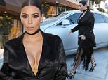 Pregnant Kim Kardashian looking dramatic at Craig's  in black and fringe arriving at dinner. July 13, 2015 X17online.com