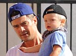 Please contact X17 before any use of these exclusive photos - x17@x17agency.com   Josh Duhamel takes Axl for a bike ride after having lunch in Brentwood. The doting July 14, 2015 X17online.com