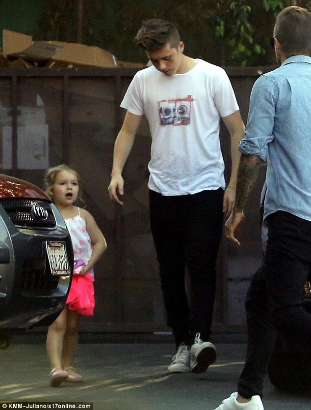 Pretty in pink: Harper Beckham was seen in a girly pink ensemble as she enjoyed a family dinner with her father David and her older brothers Brooklyn and Romeo on Wednesday