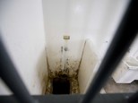 This photo shows the shower area and opening to a tunnel, where authorities claim drug lord Joaquin "El Chapo" Guzman, slipped into the tunnel to escape from his prison cell, at the Altiplano maximum security prison, in Almoloya, west of Mexico City, Wednesday, July 15, 2015. Experts have said the tunnel would have been more than a year in planning and building. The digging would have caused noise. The entrance was in a place beyond the view of security cameras at Mexico's toughest prison. They also said it was clear the escape by Mexico's most powerful drug lord must have involved inside help on a grand scale. (AP Photo/Eduardo Verdugo)