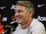 Manchester United manager Louis van Gaal, left, looks on as new signing Bastian Schweinsteiger speaks during a press conference, Wednesday, July 15, 2015, in Bellevue, Wash. Manchester United is in Seattle for an international friendly soccer match against Mexico's Club America to be played on Friday. (AP Photo/Ted S. Warren)