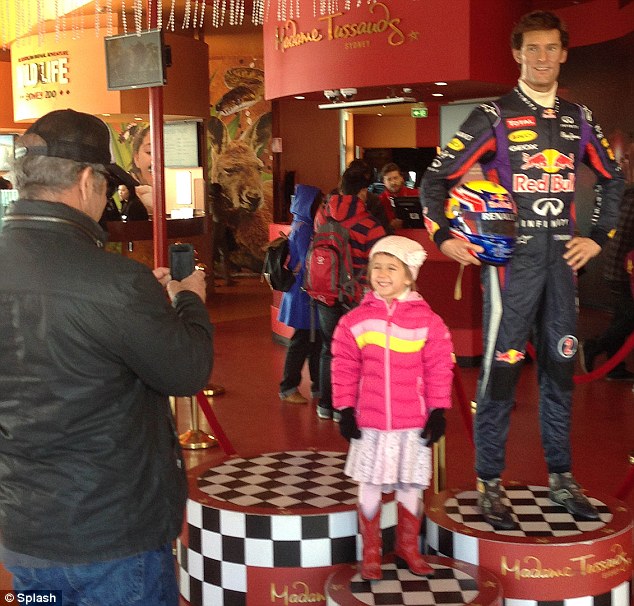 Say cheese: Mel Gibson stopped to take a picture of his daughter Lucia posing with a wax work of Formula 1 driver, Mark Webber, at the door of Madame Tussauds, Sydney