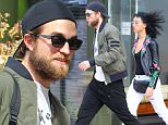 19.7.15....... Robert Pattinson and girlfriend FKA Twigs check out of their Manchester hotel on Sunday morning. Robert had been in the city to support his girlfriend who was performing as part of the Manchester International Festival.