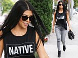 Kourtney Kardashian wears a shirt that reads NATIVE with straight dark shades and hair. Looking in a bad mood over breaking up with Scott but does some retail therapy at Trico Field, picking up some presents for her kids July 20, 2015 X17online.com