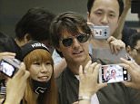 Actor Tom Cruise has his picture taken with a fan as he arrives to promote his latest movie ìMission Impossible: Rogue Nationî at the Incheon International Airport, South Korea, Thursday, July 30, 2015. (AP Photo/Ahn Young-joon)