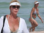 140640, EXCLUSIVE: Real Housewives of Orange County star Vicki Gunvalson wears a green and blue bikini to the beach in Miami. Vicki, who is an original cast member of the hit Bravo reality show, clad in a small bikini, showed she's fit at 53 as she took a dip in the ocean with a friend. The reality star paid tribute to the community that made her famous, with her white 'Coto de Caza' sun visor . Miami, Florida - Tuesday July 28, 2015. Photograph: Brett Kaffee ¬© Pacific Coast News. Los Angeles Office: +1 310.822.0419 sales@pacificcoastnews.com FEE MUST BE AGREED PRIOR TO USAGE