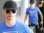 Actor, Jared Leto catches a departing flight at the Airport in Toronto, Canada. Jared Leto was showing off his Green Hair and Tattoos as he's been in Toronto filming the movie "Suicide Squad", where he's playing the role of "The Joker". Jared was also dressed very casual wearing a black baseball cap, aviator sunglasses, a blue Napal I Love You t-shirt, a Black Thirty Seconds To Mars Fanny Pack, grey sweatpants, multi-coloured striped socks, Vans running shoes, while carrying a black duffel bag with food inside. \n\nPictured: Jared Leto\nRef: SPL1092263  010815  \nPicture by: S Fernandez / Splash News\n\nSplash News and Pictures\nLos Angeles: 310-821-2666\nNew York: 212-619-2666\nLondon: 870-934-2666\nphotodesk@splashnews.com\n