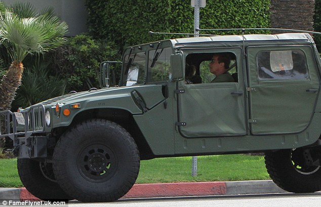 Going Commando: The action star was driving his latest squeeze around in his military vehicle
