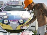 THE HAGUE, NETHERLANDS - AUGUST 01:  Chris Brown spray paints a car backstage at Vestival at Malieveld on August 1, 2015 in The Hague, Netherlands.  (Photo by Helen Boast/Redferns)
