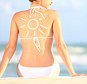 Sunscreen / sun tan lotion sun drawing on woman back. Girl in bikini sitting on beach in sunlight.; Shutterstock ID 100144169
