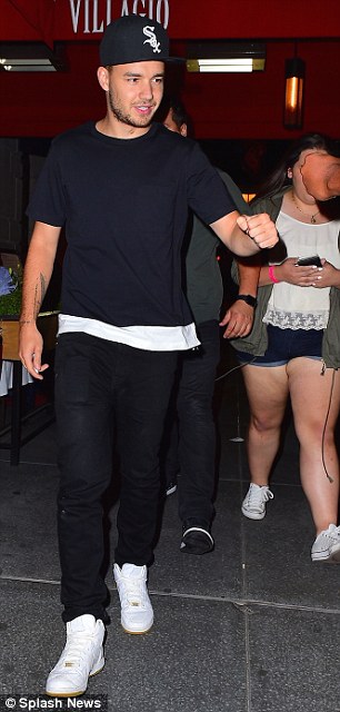 Paparazzi pals: Liam, 21, seemed in a relaxed mood as he fist-bumped one pap