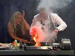 5 August 2015 - Los Angeles - USA  **** STRICTLY NOT AVAILABLE FOR USA ***  Gordon Ramsay almost sets CBS studios on fire during cooking segment with James Corden on The Late Late Show. Corden had challenged the Brit chef and his 13 year-old daughter Matilda to a cook-off to see who could create the best full English breakfast. But Ramsay kicked off a whole bunch of chaos as he decided to put his bacon directly on the electric hob to make it crispy. Instead huge clouds of smoke billowed from the hob, obscuring Ramsay and Matilda as Corden looked on stunned. Then when Ramsay put the pan back on the hob, flames shot out, leavingt Ramsay turning the  the air blue and had to have swear words bleeped six times as he patted the fire out with his apron. As the audience clapped, Corden told the chef: "Iíve got to be honest, youíre clapping but that is not what a real chef would do," before adding: "You're a joke!" Despite their mishap, the Ramsays were the first to finish their full English a