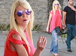 Tara Reid looking healthy except for the cigarette she's smoking with a friend after lunch in Beverly Hills. August 3, 2015. X17online.com