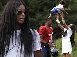 Seattle Seahawks quarterback Russell Wilson (3) looks on as his girlfriend, entertainer Ciara Harris, playfully tosses her son, Future, 14 months, in the air after an NFL football training camp Monday, Aug. 3, 2015, in Renton, Wash. (AP Photo/Elaine Thompson)