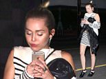 UK CLIENTS MUST CREDIT: AKM-GSI ONLY\nEXCLUSIVE: **SHOT ON 8/5/15** Santa Monica, CA - Miley Cyrus enjoyed a dinner with friends at Nobu followed by some late night fun at Shore Bar in Santa Monica.  The fashion forward pop star showed off her midriff in a white and navy blue striped crop top and matching skirt. She briefly stepped out of the bar for a smoke break and chatted it up with her pals. On her way out of Shore Bar, Miley covered her face with a black leather jacket and dashed to her ride.\n\nPictured: Miley Cyrus\nRef: SPL1096692  060815   EXCLUSIVE\nPicture by: AKM-GSI \n\n