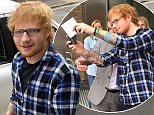 These pictures show Ed Sheeran walking out of a driving theory test centre with a massive smile on his face as he clutches his test results. See SWNS story SWED; The red-headed musician waves the papers in the air before climbing into the driver's seat of his car - but would not reveal whether he passed or failed. An employee working in the same building as the test centre in Bury St Edmonds, Suffolk, snapped the photos at around 1pm yesterday (weds). Mark Rothwell, 42, said: "He was very coy and cool when he came out. He just came out, walked over to his car and drove off.