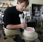 FILE  - In this March 10, 2014 file photo, Masterpiece Cakeshop owner Jack Phillips decorates a cake inside his store, in Lakewood, Colo. Phillips a suburban Denver baker who wouldnít make a wedding cake for a same-sex couple cannot cite his religious beliefs in refusing them service because it would lead to discrimination, the Colorado Court of Appeals ruled Thursday, Aug. 13, 2015. (AP Photo/Brennan Linsley, File)
