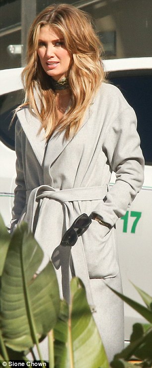 Naturally flawless: Her long tresses were styled in tousled waves that cascaded down her shoulders from a centre parting