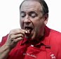 Republican presidential candidate, former Arkansas Gov. Mike Huckabee samples a pork chop while visiting the Iowa Port Tent at the Iowa State Fair, Thursday, Aug. 13, 2015, in Des Moines. (AP Photo/Charlie Riedel)