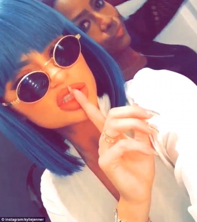 Getting the party started: Kylie seemed less coy earlier in the evening as she shared an Instagram video of her and a friend posing whilst listening to music