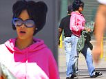 EXCLUSIVE: Rihanna was spotted out in NYC on Friday afternoon, trying to go incognito. She wore a misfitting Black Wig, which appeared in disarray as she stepped out on a breezy day . She wore a loose pink sweatshirt and baggy jeans, with large sunglasses to complete her disguise. But her signature hand tattoos gave her away.\n\nPictured: Rihanna\nRef: SPL1111000  280815   EXCLUSIVE\nPicture by:  Splash News\n\nSplash News and Pictures\nLos Angeles: 310-821-2666\nNew York: 212-619-2666\nLondon: 870-934-2666\nphotodesk@splashnews.com\n