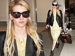 September 04, 2015: Emma Roberts returns from New Orleans and arrives at LAX airport in a yellow dress and leather motorcycle jacket in Los Angeles, CA.\nMandatory Credit: INFphoto.com Ref: inf-00