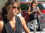 **EXCLUSIVE**     Date: September 4th 2015      Photo Credit: MOVI Inc.\nOnly Halle Berry can make grocery shopping looks this good. The stunning actress,49, looked flawless in shiny gold leather pants, high heels and a flowing black blouse as the mother of two picked up her weekly groceries at her local supermarket in Beverly Hills,Ca. \n