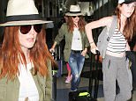 September 04, 2015: Julianne Moore, husband Bart Freundlich and their children Caleb and Liv depart from LAX airport in Los Angeles, CA.\nMandatory Credit: INFphoto.com Ref: inf-00