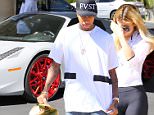 Tyga, Kylie Jenner gassing up her new Lamborghini wearing Yeezy Nikes and a new tattoo that reads, RAP STAR.  September 6, 2015