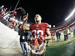In this photo taken with a fisheye lens, San Francisco 49ers running back Jarryd Hayne (38) waves to fans after an NFL preseason football game against the San Diego Chargers in Santa Clara, Calif., Thursday, Sept. 3, 2015. The 49ers won 14-12. (AP Photo/Tony Avelar)