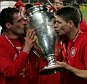 Liverpool captain Steven Gerrard (R) and defender Jamie Carragher kiss the European Cup after Liverpool won the European Champions League final against AC Milan on May 25, 2005 at the Ataturk Olympic Stadium in Istanbul, Turkey.  
UEFA Champions League Final - AC Milan v Liverpool (3-3 a.e.t.-Liverpool won 3-2 on pens).
ISTANBUL, TURKEY - MAY 25:  (Photo by Clive Brunskill/Getty Images)
52967504
EOS1DMkII-233629